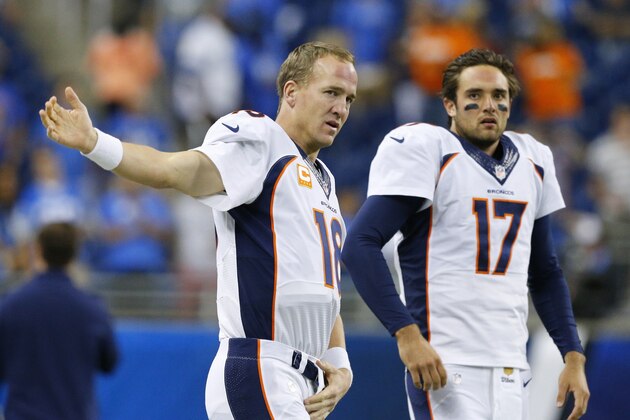 Denver Broncos quarterbacks Peyton Manning (18) and Brock Osweiler (17) stretch during warmups before an NFL football game against the Detroit Lions, Sunday, Sept. 27, 2015, in Detroit. (AP Photo/Rick Osentoski)