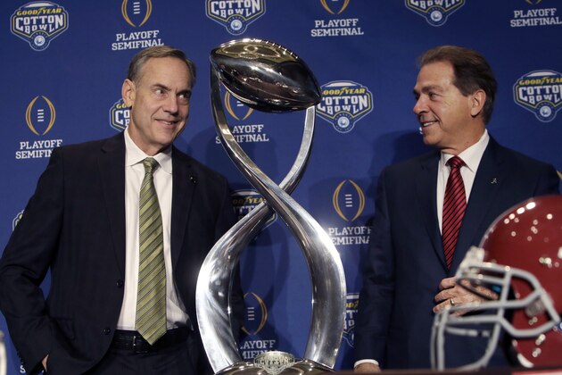 Michigan State head coach Mark Dantonio, left, and Alabama head coach Nick Saban share a light moment after posing for photos during a news conference for the Cotton Bowl NCAA college football game Wednesday, Dec. 30, 2015, in Arlington, Texas. Alabama and Michigan State face off in the Cotton Bowl, a College Football Playoff semifinal, on New Year's eve. (AP Photo/LM Otero)