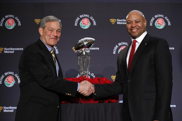 Stanford head coach David Shaw, right, and Iowa head coach Kirk Ferentz shake hands during a news conference for the Rose Bowl NCAA college football game, Wednesday, Dec. 30, 2015, in Los Angeles. Stanford and Iowa are scheduled to play on New Year's Day. (AP Photo/Jae C. Hong)