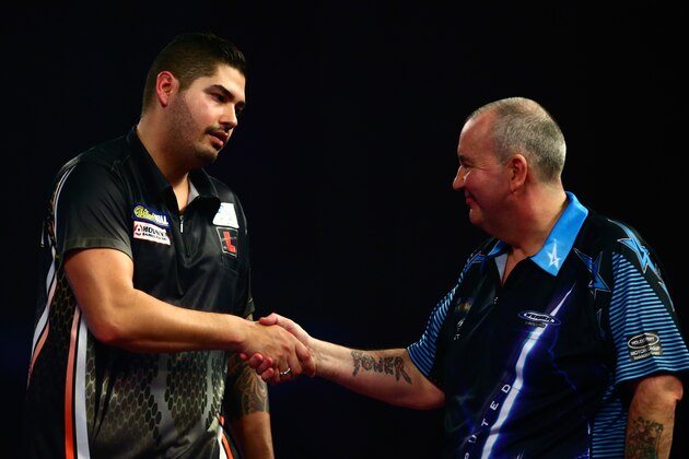 LONDON, ENGLAND - DECEMBER 30:  Jelle Klaasen of the Netherlands shakes hands with Phil Taylor of England after his victory in their third round match on Day Twelve of the 2016 William Hill PDC World Darts Championships at Alexandra Palace on December 30, 2015 in London, England.  (Photo by Jordan Mansfield/Getty Images)