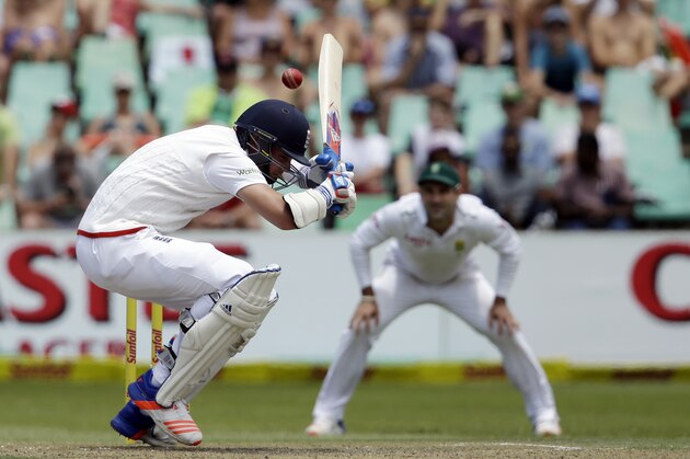 England’s batsman Stuart Broad, left, ducks under a bouncer as South Africa’s bowler Dean Elgar, right, watches on the second day of their first cricket test match at Kingsmead in Durban, South Africa, Sunday, Dec. 27, 2015. (AP Photo/Themba Hadebe)
