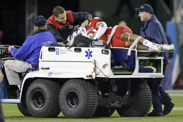 Louisville linebacker Trevon Young is taken off the field after being injured in the first half of the Music City Bowl NCAA college football game against Texas A&M Wednesday, Dec. 30, 2015, in Nashville, Tenn. (AP Photo/Mark Humphrey)