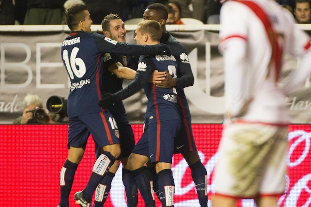 Atletico Madrid's French forward Antoine Griezmann (3rdL) celebrates with teammates after scoring during the Spanish league football match Rayo Vallecano de Madrid vs Club Atletico de Madrid at Vallecas stadium in Madrid on December 30, 2015.   AFP PHOTO/ CURTO DE LA TORRE / AFP / CURTO DE LA TORRE        (Photo credit should read CURTO DE LA TORRE/AFP/Getty Images)