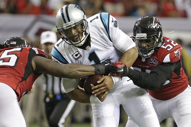 Atlanta Falcons nose tackle Jonathan Babineaux (95) and Atlanta Falcons outside linebacker Justin Durant (52) attempt a tackle on Carolina Panthers quarterback Cam Newton (1) during the first half of an NFL football game, Sunday, Dec. 27, 2015, in Atlanta. (AP Photo/David Goldman)
