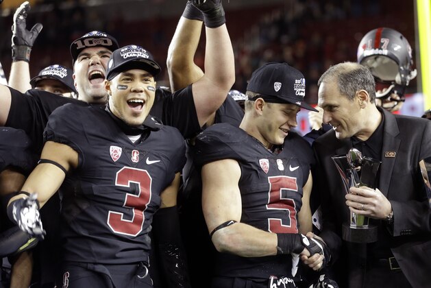 Pac-12 commissioner Larry Scott, right, presents the MVP trophy to Stanford's Christian McCaffrey (5) after Stanford defeated Southern California Saturday, Dec. 5, 2015, in Santa Clara, Calif. (AP Photo/Ben Margot)