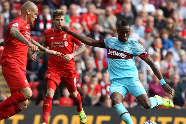 West Ham United's Senegalese striker Diafra Sakho (R) scores his team's third goal during the English Premier League football match between Liverpool and West Ham at the Anfield stadium in Liverpool, north-west England on August 29, 2015. AFP PHOTO / LINDSEY PARNABY  RESTRICTED TO EDITORIAL USE. No use with unauthorized audio, video, data, fixture lists, club/league logos or 'live' services. Online in-match use limited to 75 images, no video emulation. No use in betting, games or single club/league/player publications.        (Photo credit should read LINDSEY PARNABY/AFP/Getty Images)