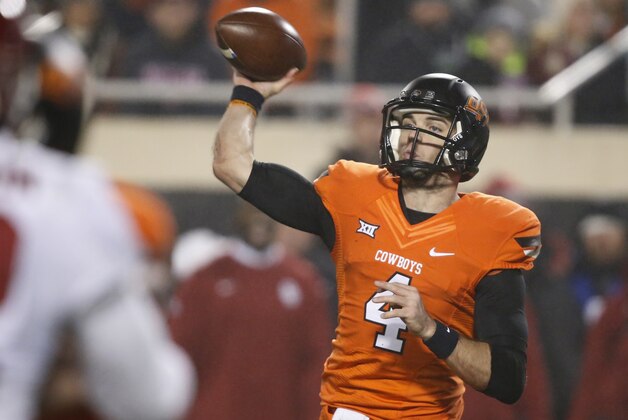 Oklahoma State quarterback J.W. Walsh (4) passes in the third quarter of an NCAA college football game in Stillwater, Okla., Saturday, Nov. 28, 2015. Oklahoma won 58-23. (AP Photo/Sue Ogrocki)