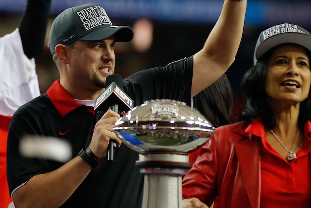 ATLANTA, GA - DECEMBER 31:  Head coach Tom Herman of the Houston Cougars celebrates alongside the trophy after their 38-24 win over the Florida State Seminoles during the Chick-fil-A Peach Bowl at the Georgia Dome on December 31, 2015 in Atlanta, Georgia.  (Photo by Kevin C. Cox/Getty Images)
