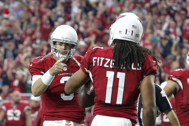 Arizona Cardinals quarterback Carson Palmer (3) points to wide receiver Larry Fitzgerald (11) after a touchdown catch during the first half of an NFL football game against the Green Bay Packers, Sunday, Dec. 27, 2015, in Glendale, Ariz. (AP Photo/Ross D. Franklin)