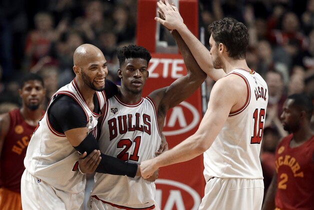 Chicago Bulls' Jimmy Butler, center, celebrates with Taj Gibson, left, and Pau Gasol after the Bulls defeated the Indiana Pacers 102-100 in overtime in an NBA basketball game Wednesday, Dec. 30, 2015, in Chicago. (AP Photo/Nam Y. Huh)