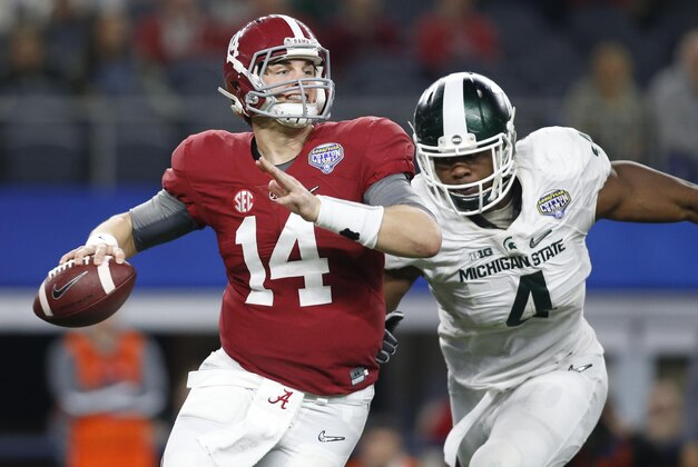 Dec 31, 2015; Arlington, TX, USA; Alabama Crimson Tide quarterback Jake Coker (14) is pressured by Michigan State Spartans defensive lineman Malik McDowell (4) in the third quarter in the 2015 CFP semifinal at the Cotton Bowl at AT&T Stadium. Mandatory Credit: Tim Heitman-USA TODAY Sports