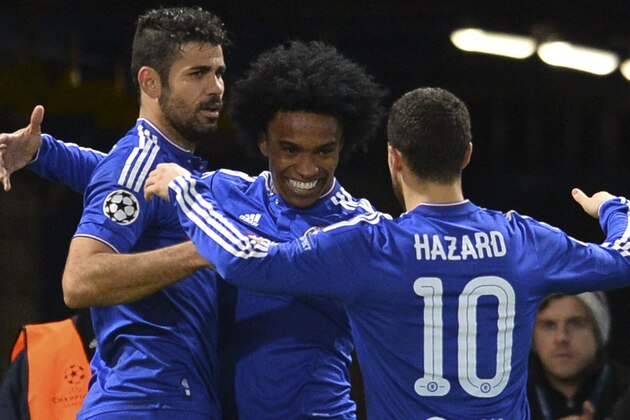 Chelsea's Brazilian midfielder Willian (C) celebrates with Chelsea's Brazilian-born Spanish striker Diego Costa (L) and Chelsea's Belgian midfielder Eden Hazard (R) after Willian scored their second goal during the UEFA Champions League Group G football match between Chelsea and Porto at Stamford Bridge in London on December 9, 2015.  AFP PHOTO / GLYN KIRK / AFP / GLYN KIRK        (Photo credit should read GLYN KIRK/AFP/Getty Images)