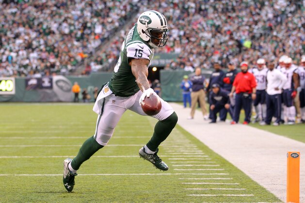 New York Jets wide receiver Brandon Marshall (15) scores a touchdown against the New England Patriots during an NFL game at MetLife Stadium in East Rutherford, N.J. on Sunday, Dec. 27, 2015. (AP Photo/Brad Penner)