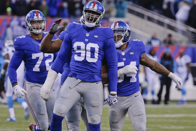 New York Giants defensive end Jason Pierre-Paul (90) celebrates with teammates during the second half of an NFL football game against the Carolina Panthers Sunday, Dec. 20, 2015, in East Rutherford, N.J. (AP Photo/Julie Jacobson)