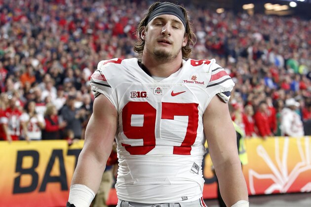 Ohio State defensive lineman Joey Bosa walks off the field after being ejected for targeting during the first half of the Fiesta Bowl NCAA College football game against Notre Dame, Friday, Jan. 1, 2016, in Glendale, Ariz.  (AP Photo/Rick Scuteri)