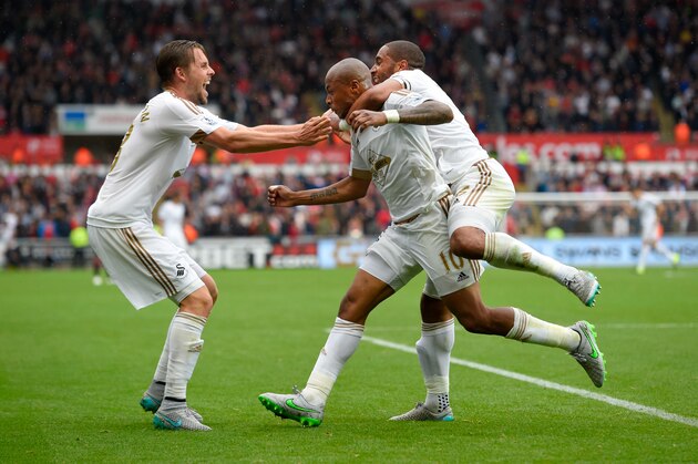 SWANSEA, WALES - AUGUST 30:  Swansea striker Andre Ayew (c) celebrates with Ashley Williams 9r0 and Gylfi Sigurdsson (l) after scoring the first swansea goal during the Barclays Premier League match between Swansea City and Manchester United on August 30, 2015 in Swansea, United Kingdom.  (Photo by Stu Forster/Getty Images)
