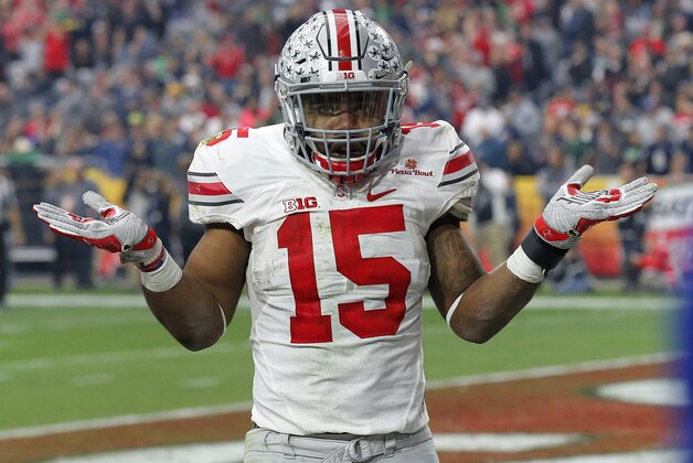 Ohio State running back Ezekiel Elliott (15) gestures as he celebrates his fourth touchdown of the game against Notre Dame  during the second half of the Fiesta Bowl NCAA College football game, Friday, Jan. 1, 2016, in Glendale, Ariz.  (AP Photo/Ross D. Franklin)