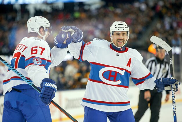 Jan 1, 2016; Foxborough, MA, USA; Montreal Canadiens center Tomas Plekanec (14) and Montreal Canadiens left wing Max Pacioretty (67) celebrate a second period goal by Montreal Canadiens right wing Brendan Gallagher (not shown) in the Winter Classic hockey game against the Boston Bruins at Gillette Stadium. Mandatory Credit: Greg M. Cooper-USA TODAY Sports