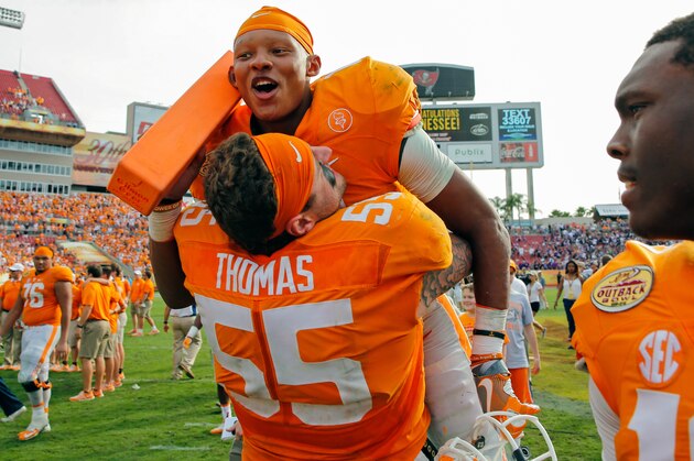 TAMPA, FL - JANUARY 1:  Joshua Dobbs #11 of the Tennessee Volunteers is lifted by Coleman Thomas #55 of the Tennessee Volunteers as they celebrate a win over Northwestern Wildcats in the Outback Bowl at Raymond James Stadium on January 1, 2016 in Tampa, Florida. (Photo by Mike Carlson/Getty Images)
