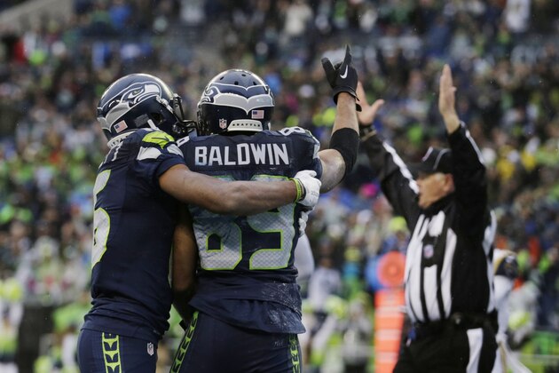 Seattle Seahawks' Doug Baldwin (89) is congratulated after scoring a touchdown against the St. Louis Rams in the first half of an NFL football game, Sunday, Dec. 27, 2015, in Seattle. (AP Photo/Stephen Brashear)