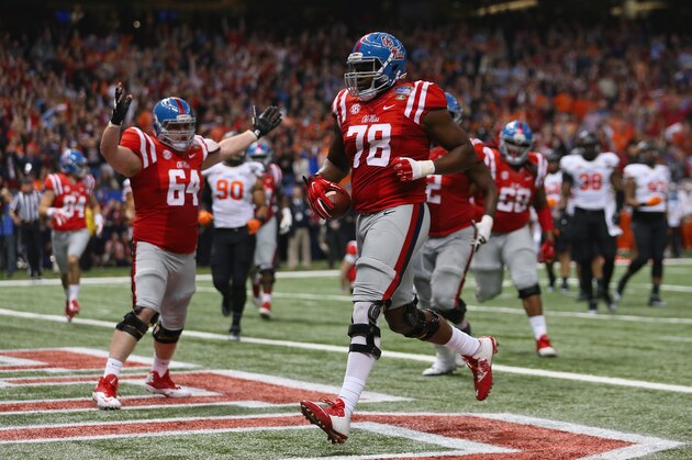 NEW ORLEANS, LA - JANUARY 01:  Laremy Tunsil #78 of the Mississippi Rebels scores runs in a touchdown during the second quarter against the Oklahoma State Cowboys in the Allstate Sugar Bowl at Mercedes-Benz Superdome on January 1, 2016 in New Orleans, Louisiana.  (Photo by Chris Graythen/Getty Images)