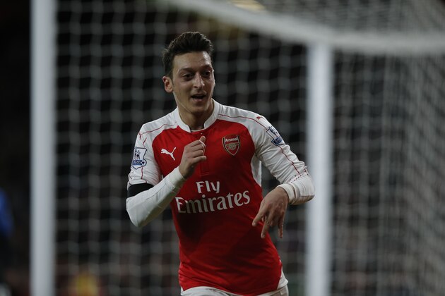 Arsenal's German midfielder Mesut Ozil celebrates after scoring their second goal during the English Premier League football match between Arsenal and Bournemouth at the Emirates Stadium in London on December 28, 2015. AFP PHOTO / ADRIAN DENNIS

RESTRICTED TO EDITORIAL USE. No use with unauthorized audio, video, data, fixture lists, club/league logos or 'live' services. Online in-match use limited to 75 images, no video emulation. No use in betting, games or single club/league/player publications. / AFP / ADRIAN DENNIS        (Photo credit should read ADRIAN DENNIS/AFP/Getty Images)