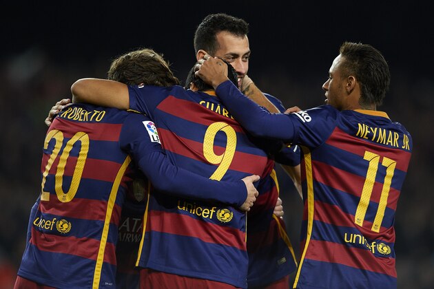BARCELONA, SPAIN - DECEMBER 30:  Luis Suarez (9) of FC Barcelona celebrates with his teammates Neymar, Sergi Roberto and Sergio Busquets after scoring his team's third goal during during the La Liga match between FC Barcelona and Real Betis Balompie at Camp Nou on December 30, 2015 in Barcelona, Spain.  (Photo by Manuel Queimadelos Alonso/Getty Images)