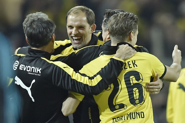 Dortmund head coach Thomas Tuchel, center,  celebrates after the German Bundesliga soccer match between Borussia Dortmund and FC Schalke 04 in Dortmund, Germany, Sunday, Nov. 8, 2015. Dortmund defeated Schalke with 3-2. (AP Photo/Martin Meissner)