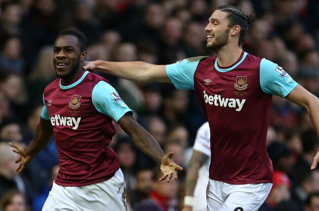West Ham United's English midfielder Michail Antonio celebrates with West Ham United's English striker Andy Carroll (R) after scoring the opening goal of the English Premier League football match between West Ham United and Liverpool at The Boleyn Ground in Upton Park, East London on January 2, 2016. AFP PHOTO / JUSTIN TALLIS

RESTRICTED TO EDITORIAL USE. No use with unauthorized audio, video, data, fixture lists, club/league logos or 'live' services. Online in-match use limited to 75 images, no video emulation. No use in betting, games or single club/league/player publications. / AFP / JUSTIN TALLIS        (Photo credit should read JUSTIN TALLIS/AFP/Getty Images)