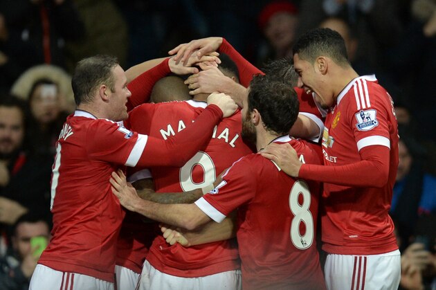 Manchester United's French striker Anthony Martial (C) is congratulated by teammates during the English Premier League football match between Manchester United and Swansea City at Old Trafford in Manchester, north west England, on January 2, 2016. AFP PHOTO / OLI SCARFF

RESTRICTED TO EDITORIAL USE. No use with unauthorized audio, video, data, fixture lists, club/league logos or 'live' services. Online in-match use limited to 75 images, no video emulation. No use in betting, games or single club/league/player publications. / AFP / OLI SCARFF        (Photo credit should read OLI SCARFF/AFP/Getty Images)