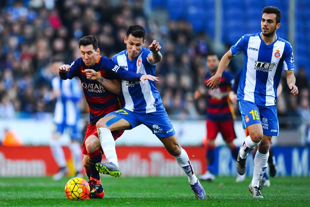 BARCELONA, SPAIN - JANUARY 02:  Lionel Messi of FC Barcelona competes for the ball Hernan Perez of RCD Espanyol during the La Liga match between RCD Espanyol and FC Barcelona at Cornella-El Prat Stadium on January 2, 2016 in Barcelona, Spain.  (Photo by David Ramos/Getty Images)