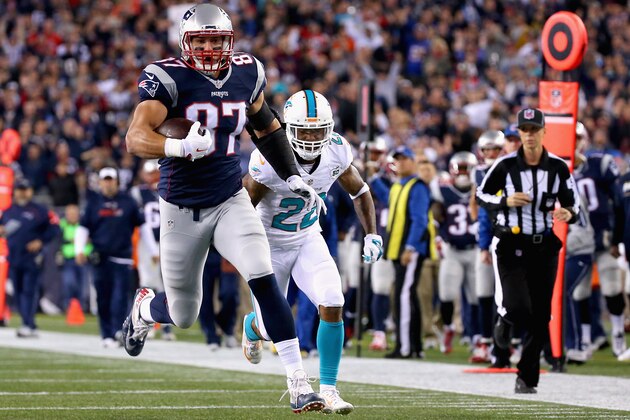 FOXBORO, MA - OCTOBER 29:  Rob Gronkowski #87 of the New England Patriots carries the ball as he scores a touchdown during the first quarter against the Miami Dolphins at Gillette Stadium on October 29, 2015 in Foxboro, Massachusetts.  (Photo by Jim Rogash/Getty Images)