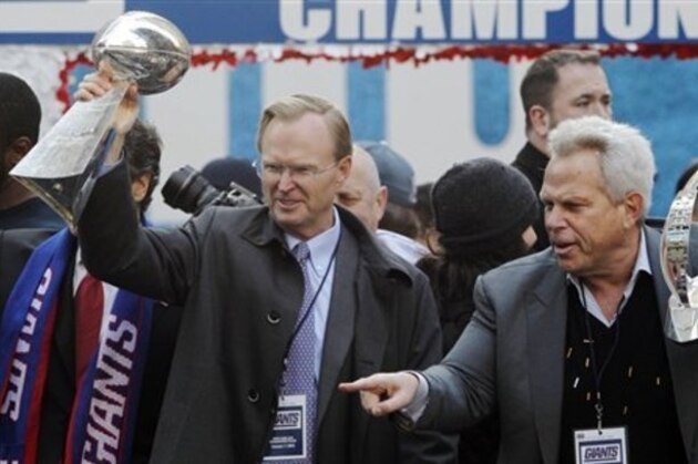 New York Giants co-owners John Mara, left, holding the Vince Lombardi Trophy, and Steve Tisch, holding the Halas Trophy, celebrate during the team's NFL football Super Bowl parade in New York, Tuesday, Feb. 7, 2012. The Giants beat the New England Patriots 21-17 on Sunday in Indianapolis. (AP Photo/Julio Cortez)