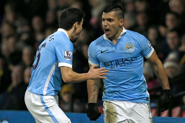 Manchester City's Argentinian striker Sergio Aguero celebrates with Manchester City's Spanish midfielder Jesus Navas (L) after scoring their second goal during the English Premier League football match between Watford and Manchester City at Vicarage Road Stadium in Watford, north of London on January 2, 2016. AFP PHOTO / ADRIAN DENNISRESTRICTED TO EDITORIAL USE. NO USE WITH UNAUTHORIZED AUDIO, VIDEO, DATA, FIXTURE LISTS, CLUB/LEAGUE LOGOS OR 'LIVE' SERVICES. ONLINE IN-MATCH USE LIMITED TO 75 IMAGES, NO VIDEO EMULATION. NO USE IN BETTING, GAMES OR SINGLE CLUB/LEAGUE/PLAYER PUBLICATIONS. / AFP / ADRIAN DENNIS        (Photo credit should read ADRIAN DENNIS/AFP/Getty Images)