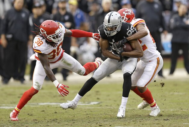Oakland Raiders wide receiver Amari Cooper (89) runs against Kansas City Chiefs defensive back Ron Parker (38) and cornerback Marcus Peters during an NFL football game in Oakland, Calif., Sunday, Dec. 6, 2015. (AP Photo/Ben Margot)