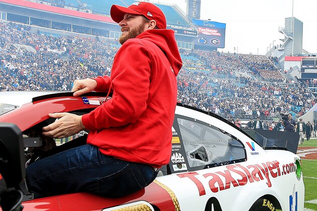 JACKSONVILLE, FL - JANUARY 02: Dale Earnhardt Jr, driver of the TaxSlayer.com Chevrolet, gets out of his race car on the field before the TaxSlayer Bowl game between the Georgia Bulldogs and the Penn State Nittany Lions at EverBank Field between the Georgia Bulldogs and the Penn State Nittany Lions on January 2, 2016 in Jacksonville, Florida. (Photo by Rob Foldy/Getty Images)