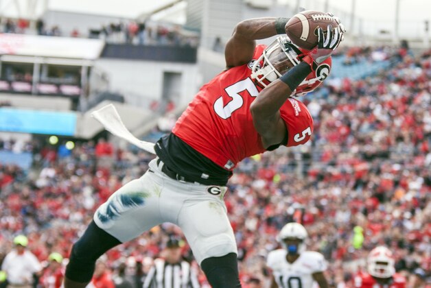 George wide receiver Terry Godwin catches a pass in the end zone for touchdown during the first half of the TaxSlayer Bowl NCAA college football game against Penn State in Jacksonville, Fla., Saturday, Jan. 2, 2016.  (AP Photo/Mark Wallheiser)