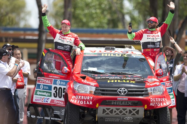 Toyota driver Saudi Arabia’s Yazeed Alrajhi and co-driver Germany’s Timo Gottschalk, wave to the public from the podium ramp during the symbolic start of the Dakar Rally 2016, in Buenos Aires, Argentina, Saturday, Jan. 2, 2016. The race will start on Jan. 3, passing through Bolivia. (AP Photo/Natacha Pisarenko)
