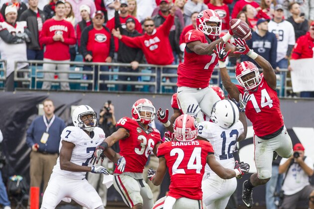 Georgia's Lorenzo Carter (7) and Malkom Parrish knock down a Penn State pass on the last play of the game to preserve the Bulldog's 24-17 victory in the TaxSlayer Bowl NCAA college football game in Jacksonville, Fla., Saturday, Jan. 2,  2016.  (AP Photo/Mark Wallheiser)