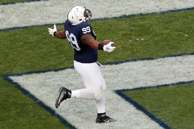 Penn State defensive tackle Austin Johnson (99) celebrates as he scores a touchdown after recovering a fumble by San Diego State  quarterback Maxwell Smith during the second half of an NCAA college football game in State College, Pa., Saturday, Sept. 26, 2015. Penn State  won 37-21. (AP Photo/Gene J. Puskar)