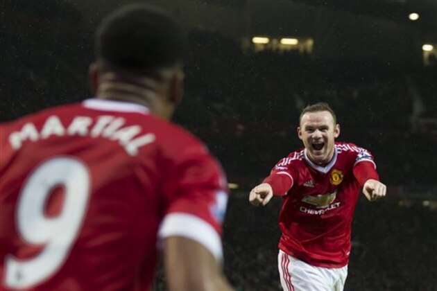 Manchester United's Wayne Rooney, right, celebrates with teammate Anthony Martial after scoring during the English Premier League soccer match between Manchester United and Swansea City at Old Trafford Stadium, Manchester, England, Saturday, Jan. 2, 2016. (AP Photo/Jon Super)