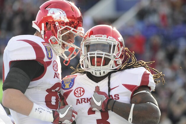 Jan 2, 2016; Memphis, TN, USA; Arkansas Razorbacks running back Alex Collins (3) and Arkansas Razorbacks tight end Jeremy Sprinkle (83) celebrate a touchdown during the first half against the Kansas State Wildcats at Liberty Bowl. Mandatory Credit: Justin Ford-USA TODAY Sports