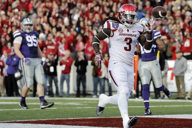 Arkansas running back Alex Collins (3) scores a touchdown on a 13-yard run against Kansas State in the first half of the Liberty Bowl NCAA college football game Saturday, Jan. 2, 2016, in Memphis, Tenn. (AP Photo/Mark Humphrey)