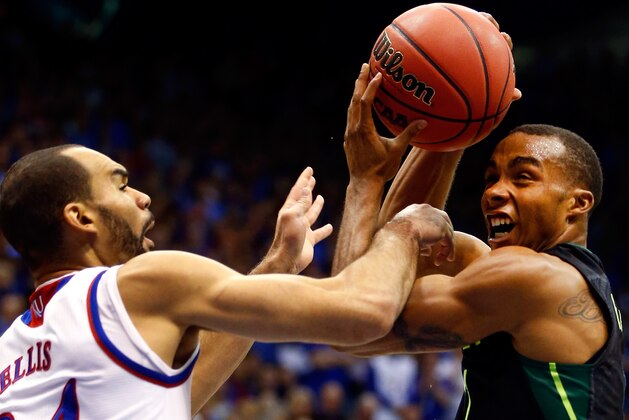 LAWRENCE, KS - JANUARY 02:  Lester Medford #11 of the Baylor Bears tries to shoot as Perry Ellis #34 of the Kansas Jayhawks defends during the game at Allen Fieldhouse on January 2, 2016 in Lawrence, Kansas.  (Photo by Jamie Squire/Getty Images)