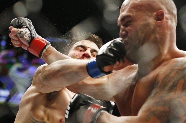 Robbie Lawler, right, trades blows with Carlos Condit during a welterweight championship mixed martial arts bout at UFC 195, Saturday, Jan. 2, 2016, in Las Vegas. (AP Photo/John Locher)