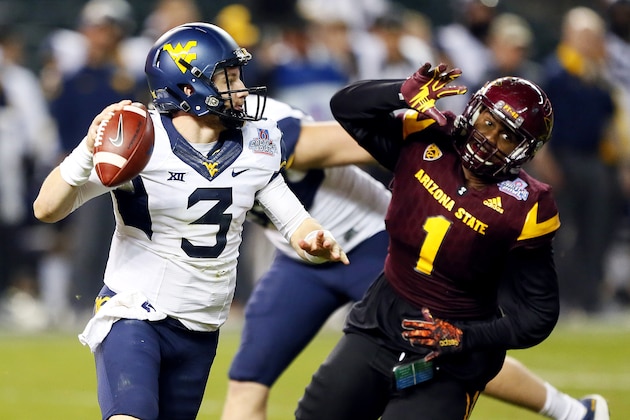 West Virginia quarterback Skyler Howard (3) looks to pass as Arizona State defensive lineman JoJo Wicker (1) pursues during the second half of the Cactus Bowl NCAA college football game, Saturday, Jan. 2, 2016, in Phoenix. (AP Photo/Matt York)