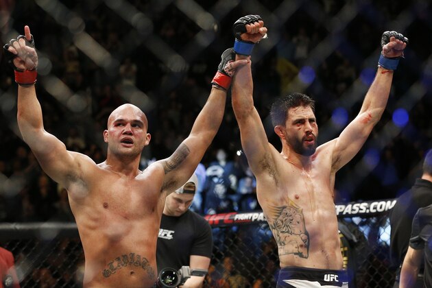 Robbie Lawler, left, and Carlos Condit celebrate after their welterweight championship mixed martial arts bout at UFC 195, Saturday, Jan. 2, 2016, in Las Vegas. Lawler won the bout. (AP Photo/John Locher)
