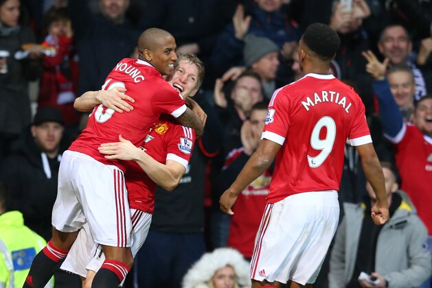 MANCHESTER, ENGLAND - JANUARY 02:  Anthony Martial (R) of Manchester United celebrates scoring his team's first goal with his team mates Ashley Young (L) and Bastian Schweinsteiger (C) during the Barclays Premier League match between Manchester United and Swansea City at Old Trafford on January 2, 2016 in Manchester, England.  (Photo by Alex Livesey/Getty Images)