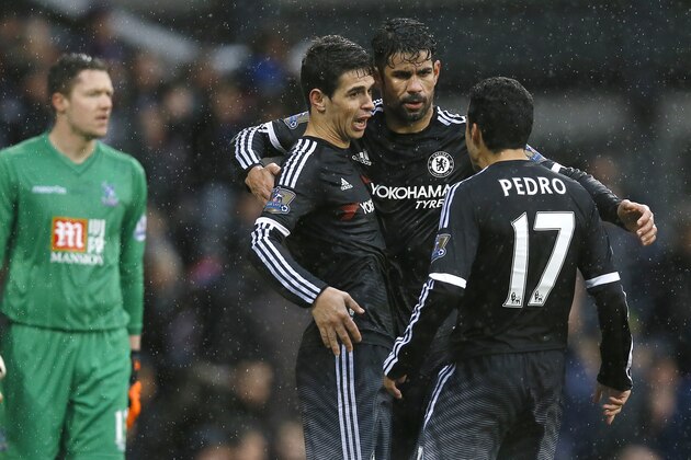 Chelsea's Oscar, front left, hugs Diego Costa, centre, and, Pedro, right, as he celebrates scoring a goal during the English Premier League soccer match between Crystal Palace and Chelsea at Selhurst Park stadium in London, Sunday, Jan. 3, 2016. (AP Photo/Kirsty Wigglesworth)