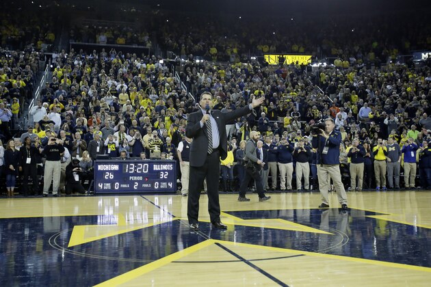 ANN ARBOR, MI - DECEMBER 30:  Jim Harbaugh addresses the crowd at Crisler Arena during halftime of the Michigan Wolverines basketball game against the Illinois Fighting Illini after being announced as the new football coach at a news conference earlier in the day December 30, 2014 in Ann Arbor, Michigan. (Photo by Duane Burleson/Getty Images)